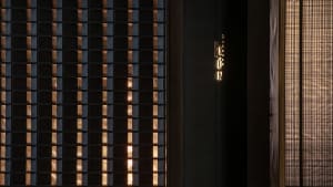 A dimly lit room with two doorways, one on the left and one on the right, creating a sense of mystery