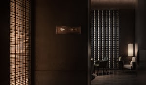 Modern room with a wooden floor, two chairs, and a sign on the wall