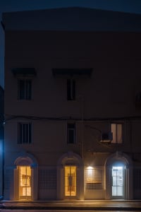 Two modern buildings with three floors, windows, and clean lines, set on a street with a calm and inviting atmosphere