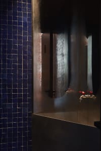 Modern bathroom with a glass shower, dual sinks, and well-lit design