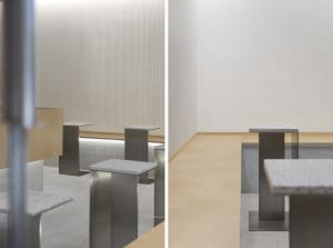 Empty classroom with wooden paneling, benches, and chairs, creating a warm and inviting learning environment