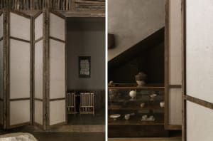 Cozy living space with a dining area, wooden door, and staircase, featuring a glass table, wooden accents, and comfortable seating