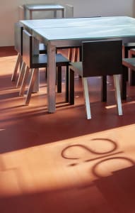 A dining area with a long metal table surrounded by chairs, creating a comfortable seating arrangement for gatherings and meals