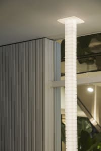 Contemporary indoor space with a metal staircase, potted plants, and modern decor