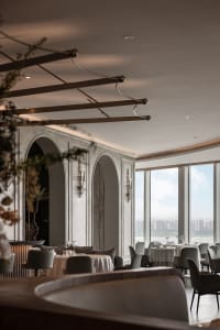 Sophisticated dining space with wooden accents, well-lit surroundings, and tasteful decorations