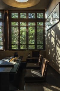 A cozy dining space with a table, chairs, and a potted plant, suggesting a warm and inviting atmosphere