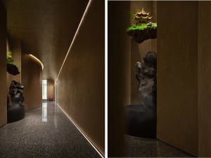 Asian-inspired interior design with Chinese artwork, a rock garden, and a combination of living and dining areas with chairs and a potted plant