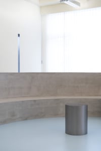 Empty minimalist room with a concrete bench in the center, featuring a simple, functional space with no decorative elements or additional features