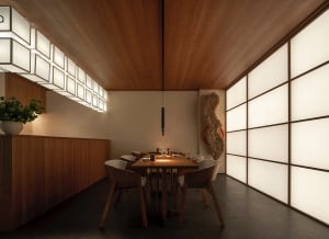 Empty restaurant dining area with a wooden table and four chairs, set up for dinner service, creating a cozy atmosphere