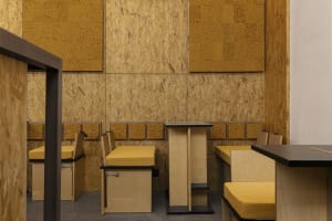 Warm and inviting restaurant interior with wooden walls and tables, comfortable seating, and rustic charm
