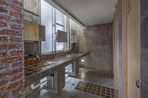 Modern bathroom with a marble countertop and sink area, giving off a luxurious vibe