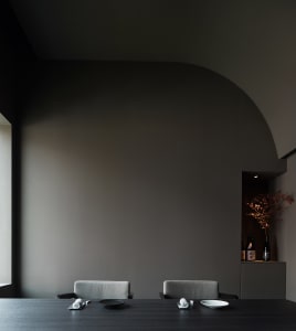 Empty dining area with two chairs and a small table in a calm and inviting atmosphere