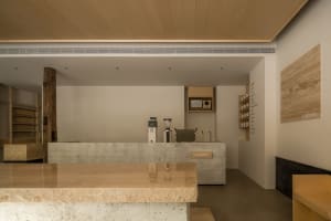 A modern coffee shop interior with a marble counter, two coffee machines, and two cups, featuring a stylish and luxurious atmosphere