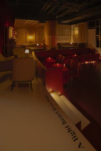 Inviting restaurant interior with red walls, white tables, and comfortable seating areas