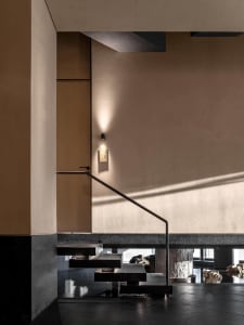 Modern staircase with metal steps, well-lit with clean lines and minimalistic design elements