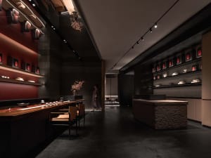 A black and white themed restaurant with a dining area featuring chairs around a table, vases, and stone flooring, conveying elegance and intimacy