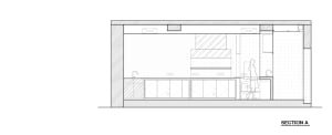 Empty modern kitchen with white cabinets, black countertops, and a focus on simplicity and efficiency