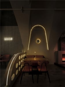 Warm and inviting dining space with wood and metal elements, multiple light sources, and comfortable seating options