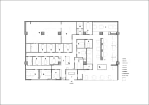 2D floor plan of a modern office building with various rooms and spaces, including hallways and offices, with clear lines and minimal clutter