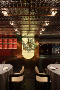 Elegant dining space with a large dome, chairs, and a dining table, set in a sophisticated environment