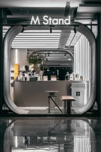 Cozy cafe interior with a counter, potted plants, and various decorative items