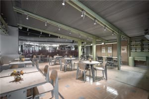 A warm and inviting dining area with multiple tables and chairs, perfect for socializing and enjoying meals together