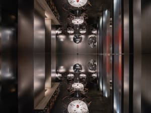 A modern restaurant dining area with multiple tables and chairs, featuring a stylish and inviting atmosphere