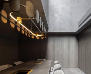 A modern dining space with a marble table surrounded by chairs, creating a sophisticated atmosphere