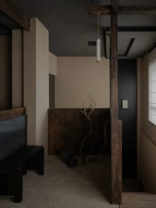 Bathroom with wooden walls and floors, featuring two sinks and a warm inviting ambiance