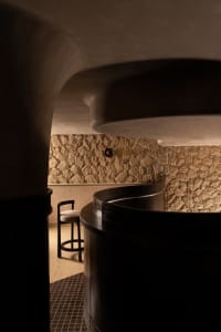 A cozy bar area with a round table and chairs, a bar counter, and inviting ambiance