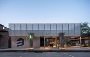 Modern commercial building with a glass front, metal and glass elements, and large windows allowing natural light to fill the interior spaces