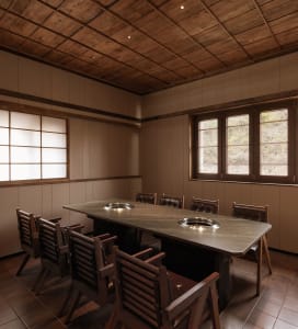 Cozy dining space with a wooden table and chairs, surrounded by warm wood elements and a traditional style