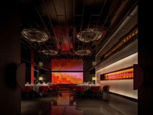 A modern restaurant interior with multiple tables, chairs, wine glasses, and artwork, set in a warm and inviting atmosphere with clean lines and minimalist decoration