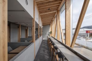 A bright and inviting dining space with multiple wooden tables and chairs, offering ample seating options