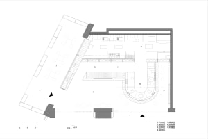White and black floor plan of a modern hotel with dining area, kitchen, and living spaces
