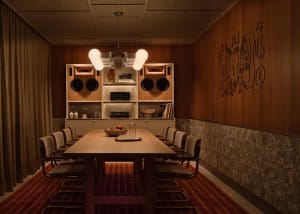 A warm and inviting kitchen dining area with a wooden theme, featuring a dining table, chairs, and natural light
