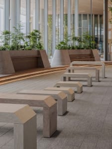 A public space with several wooden benches in various positions, creating a comfortable and inviting atmosphere for relaxation and socialization