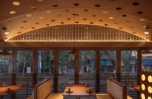Warm and inviting restaurant interior with wooden tables and chairs, featuring multiple cups and a cozy atmosphere