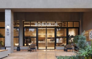 Spacious Asian restaurant with glass door, modern furniture, and clean lines