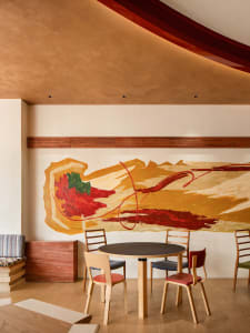 A warm and inviting dining area with a wooden table and chairs, perfect for socializing and dining
