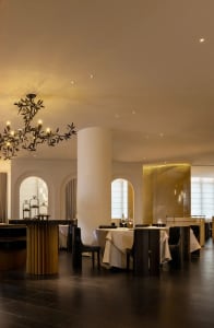 Sophisticated dining space with wooden furniture, wine glasses, and well-lit surroundings