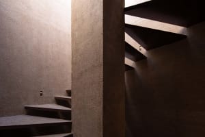 A photo of a stairwell with stone steps, creating a sense of depth and structure within the building