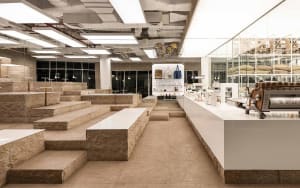 An open dining and social space with a large white countertop surrounded by benches, creating a comfortable atmosphere for various activities