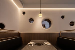 Empty restaurant dining area with multiple round tables and chairs, clean and inviting atmosphere