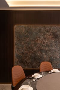 Dining area with leather chairs, a dining table, and multiple plates, set in an elegant and inviting atmosphere