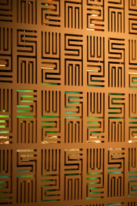 Abstract geometric design featuring a pattern of squares and rectangles in a modern space with wood and metal elements