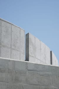 A modern building with concrete walls and a cement structure, featuring a minimalist and functional design