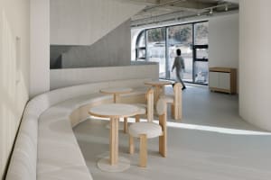 A warm and inviting restaurant interior with wooden tables and chairs, creating a comfortable seating arrangement for guests