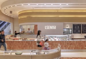 Casual Scandinavian cafe with a brick wall, a cafeteria area, and people walking around