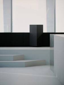 Modern white building with black accents, large window, and two steps leading up to the entrance